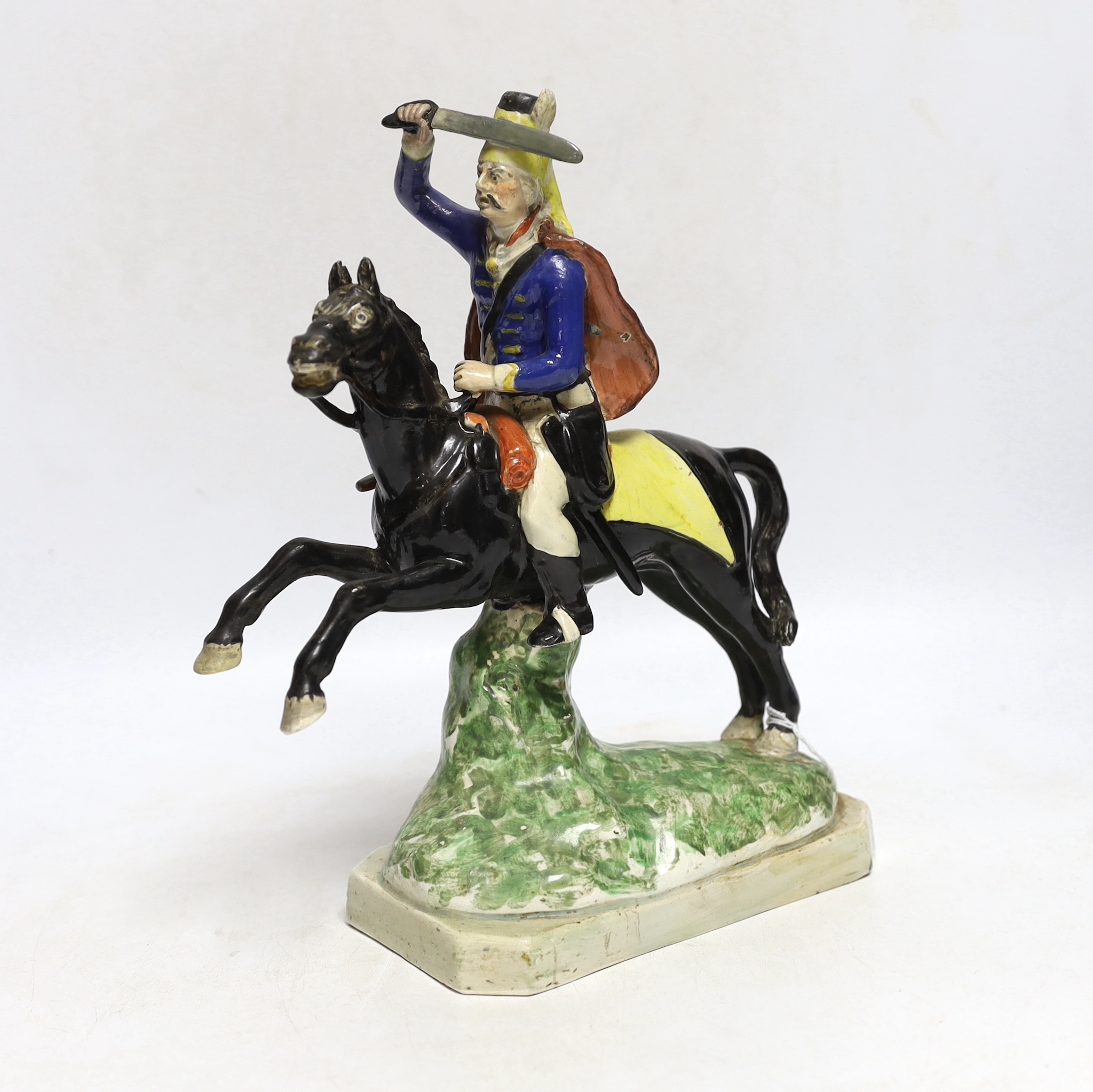 A Staffordshire pearlware group of a Hussar on a leaping horse, c.1820, restored, 27cm high